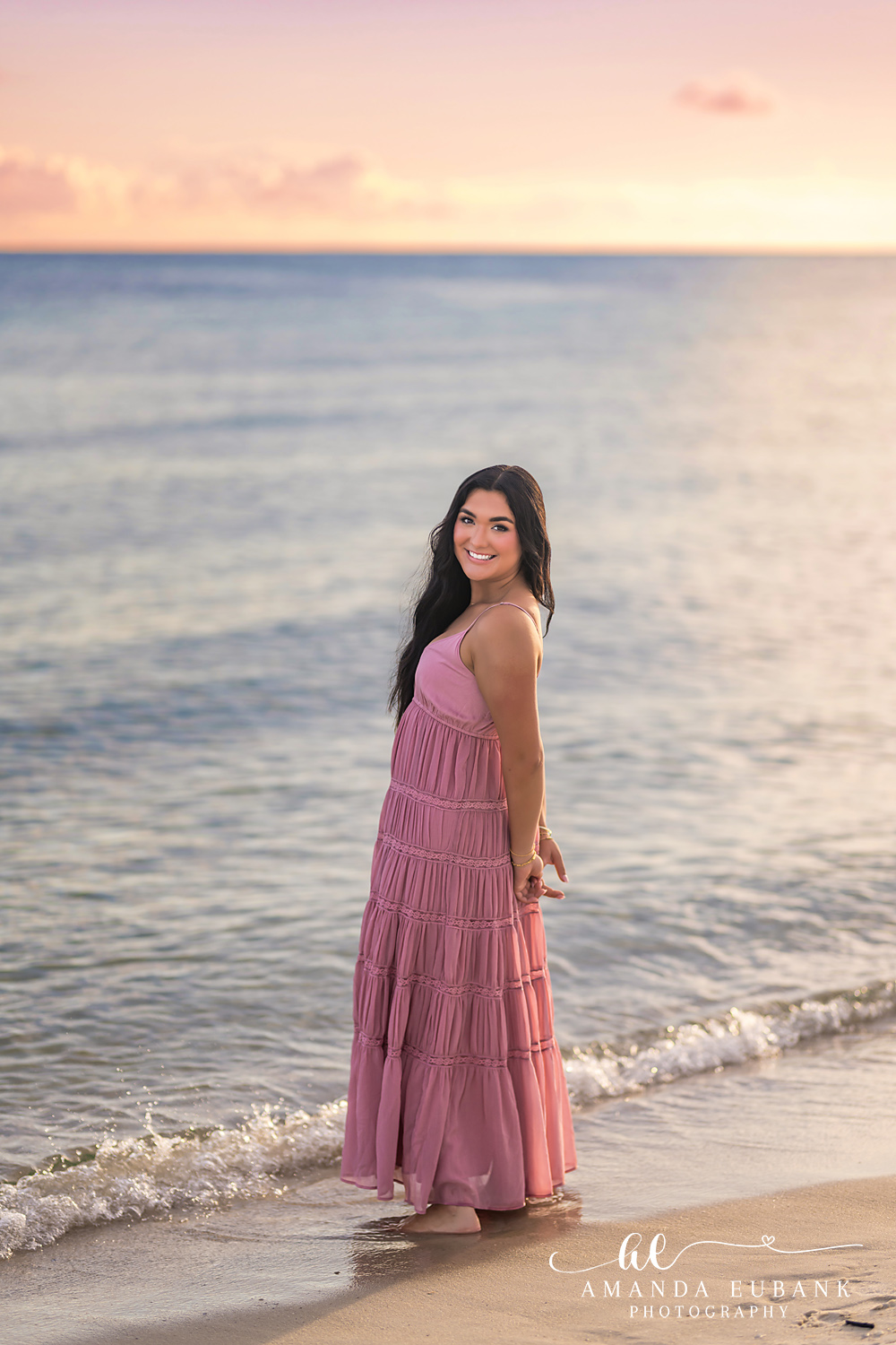 Rosemary Beach Senior Photos | Pink dress at the water’s edge Rosemary Beach senior photographer: senior girl in a pink maxi dress standing at the water's edge looking back over her shoulder