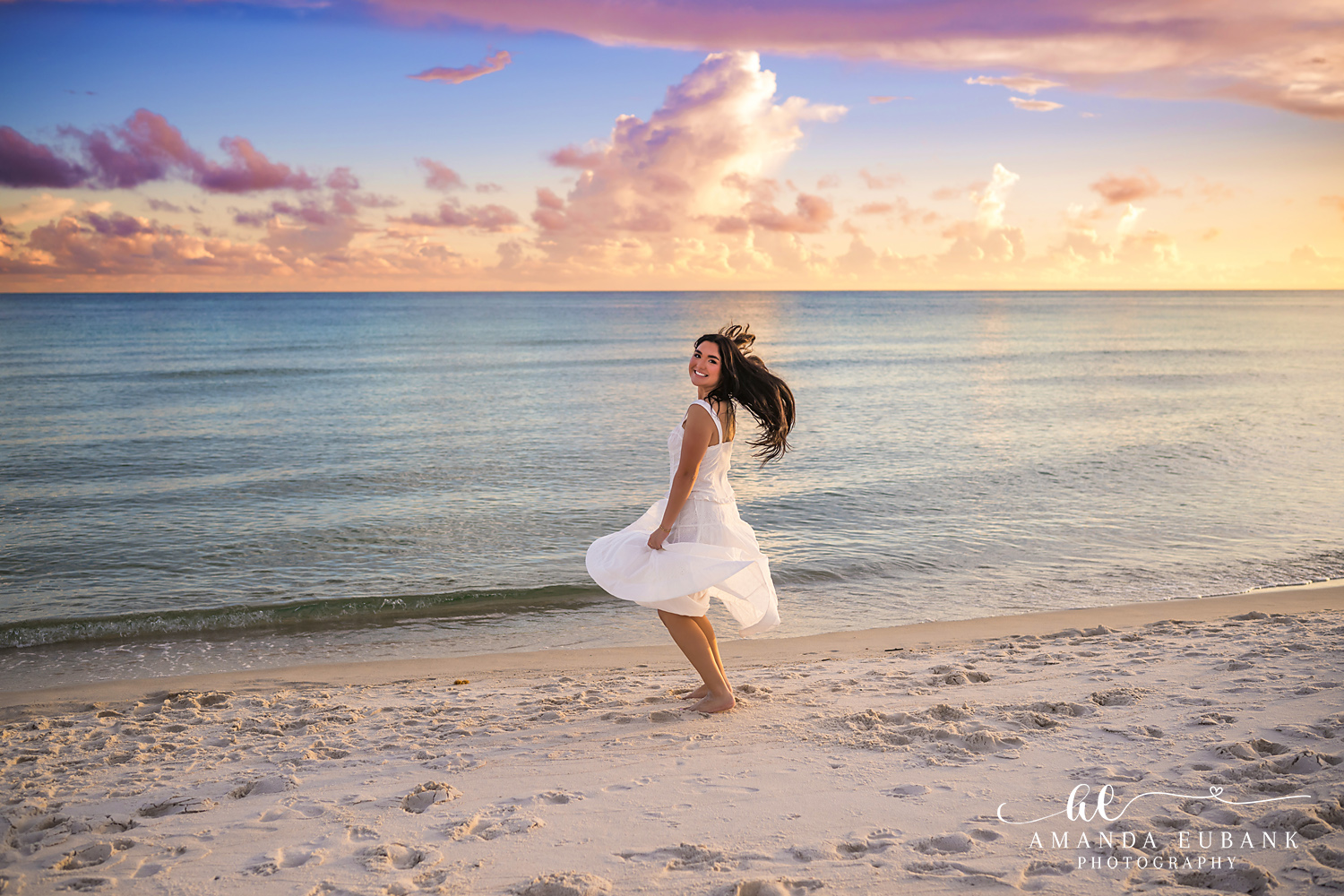 Rosemary Beach Senior Photos | Twirl at the shoreline Rosemary Beach senior photographer: senior girl twirling in a white dress at the shoreline with colorful clouds over the Gulf